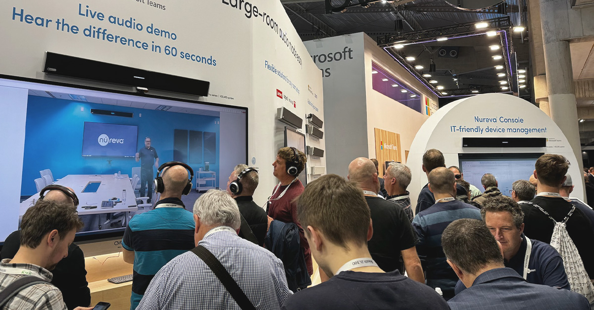 People crowd into the Nureva ISE 2024 stand to hear an audio demo and learn about our solutions